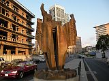 Beirut Corniche 10 A Sculpture Of A Flame Called The Torch Sits Next To The Bombed Out St Georges Hotel With Platinum Tower Behind 